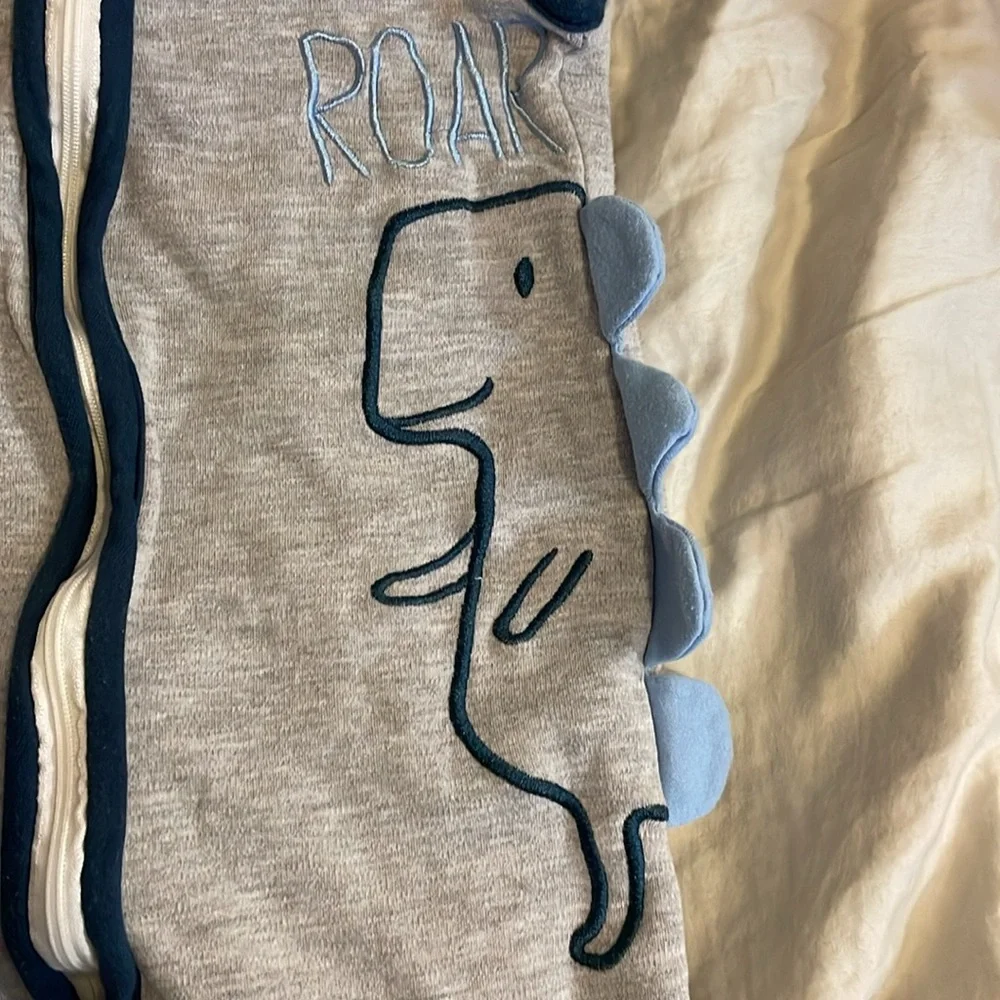 Dinosaur sleep sack swaddle arms out